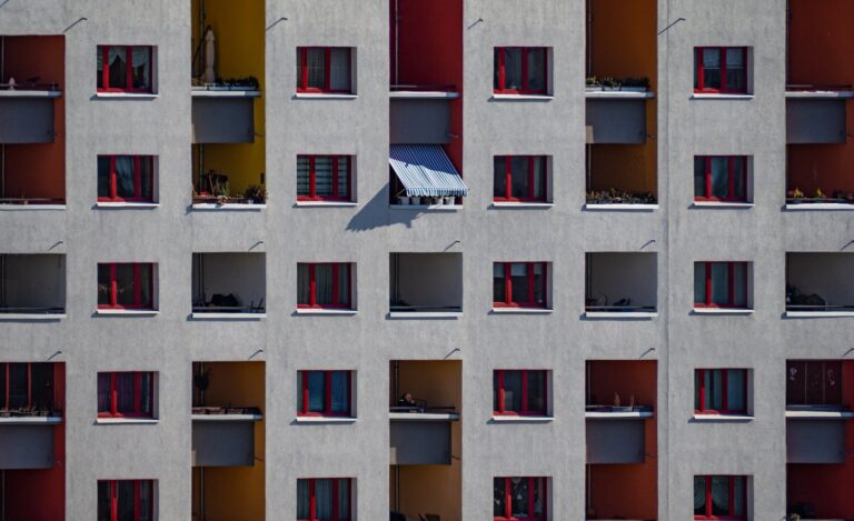 Close-up of a vibrant modern apartment facade with balconies in Berlin.
