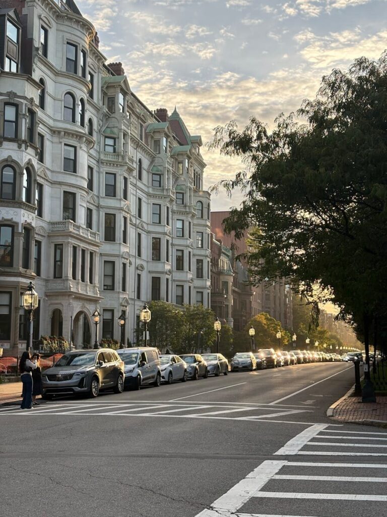 Elegant Boston street with historic architecture at sunset, showcasing urban charm and tranquility.